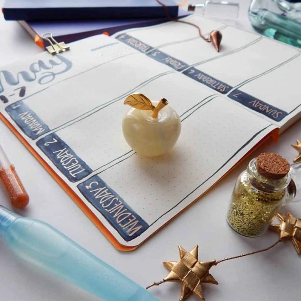 closeup of Basic Betty weekly spread with decorative apple sitting on the page