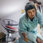 woman painting on a canvas with text overlay