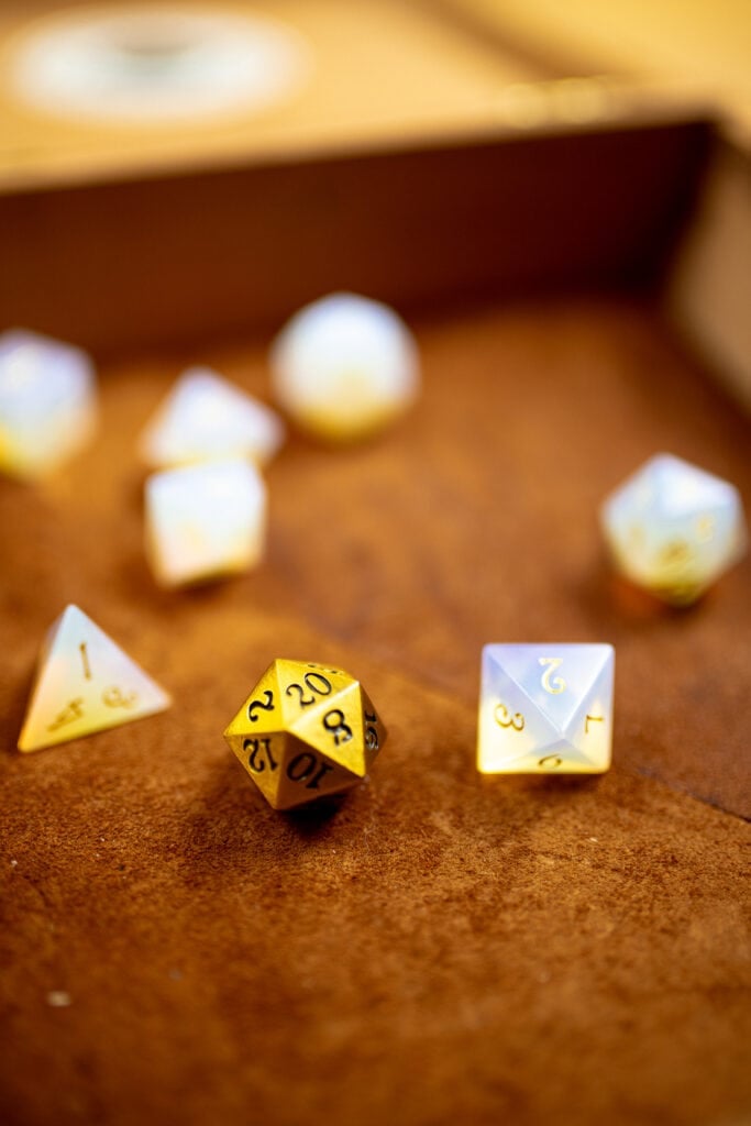 Assortment of dice in a suede lined tray.